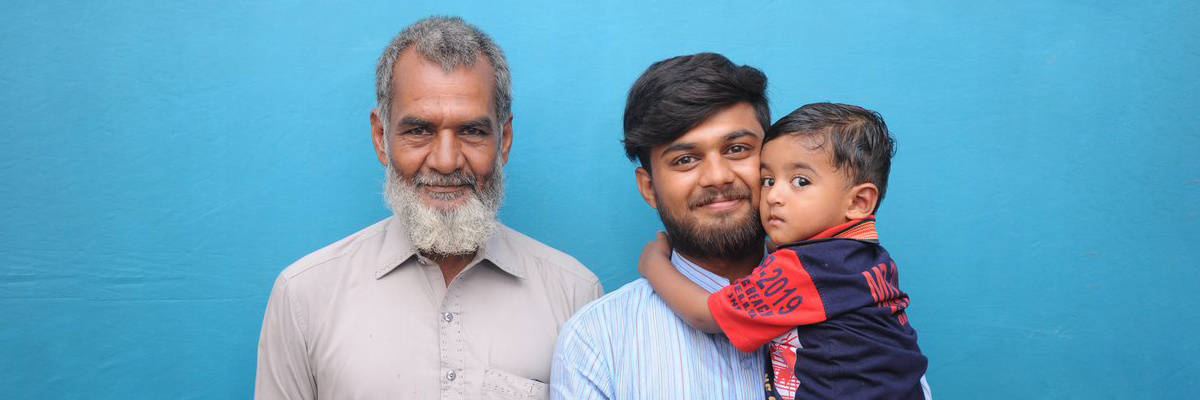 An image of a south asian man with his father and child.