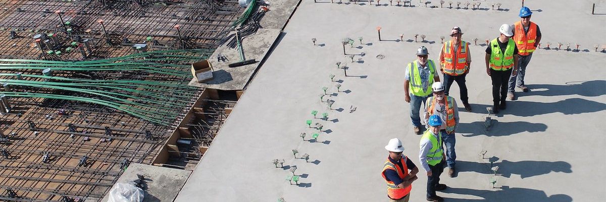 A photograph showing a number of skilled trades people standing in a construction site.