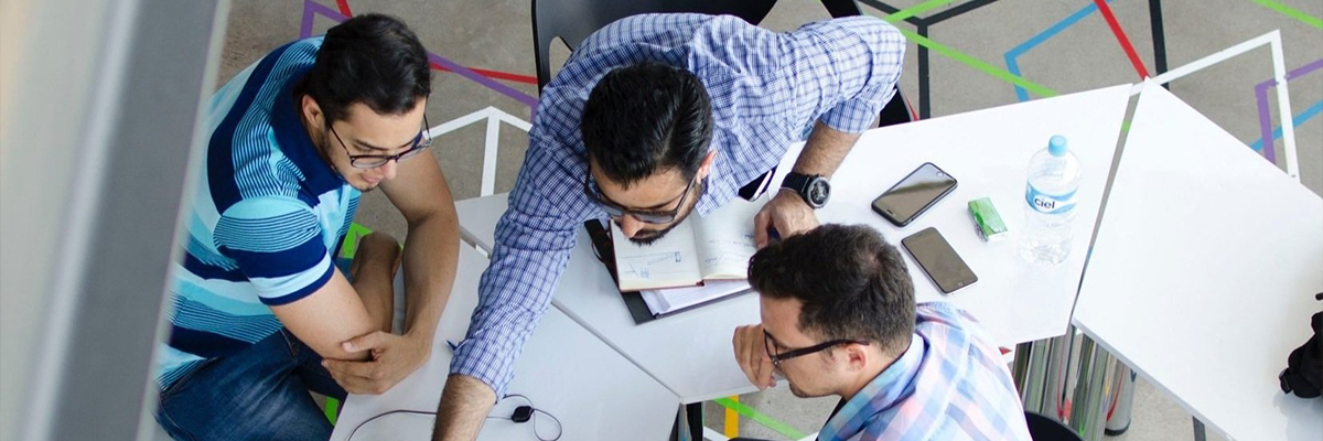 A photograph of several colleagues working in a casual office space.