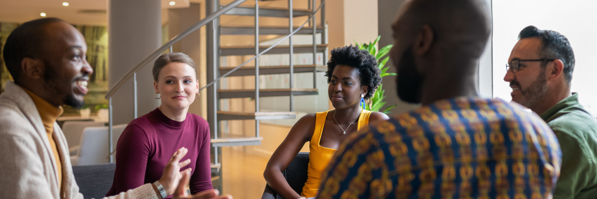 A photographic image of people discussing in a circle