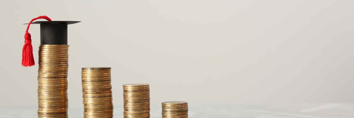 A photographic image showing coins and a graduation cap.