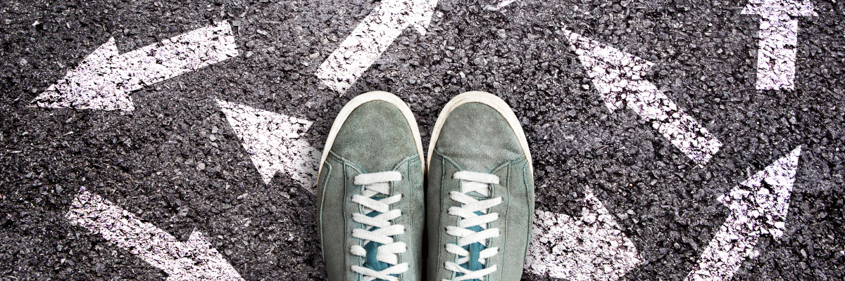 Photographic style image of shoes and arrows.