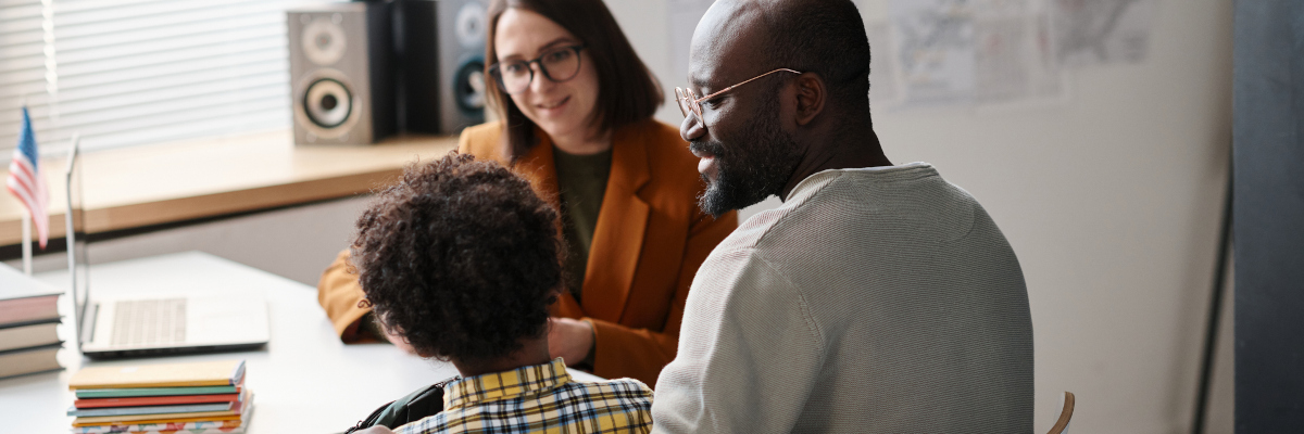 Photographic style image of a family talking to a teacher.